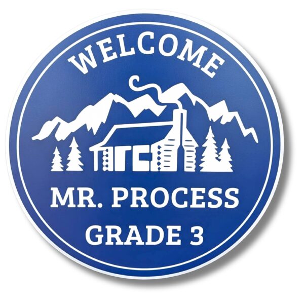 Sign in blue with white text and graphics: Welcome at the top, featuring an illustration of a cabin amidst trees and mountains, resembling charming coastal decor. The bottom reads Mr. Process Grade 3.