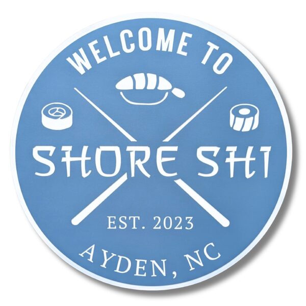 A round blue Personalized Custom Round Beach House Sign features the white text Welcome to Shore Shi, embellished with sushi rolls, crossed chopsticks, Est. 2023, and Ayden, NC.