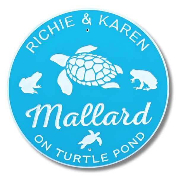 A personalized round beach house sign features charming illustrations of turtles and frogs, with text saying Richie & Karen Mallard on Turtle Pond.