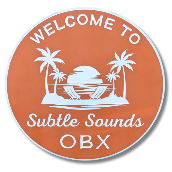 An orange round beach house sign featuring the text Welcome to Subtle Sounds OBX with palm trees and a setting sun over ocean waves. Product: Personalized Custom Round Beach House Sign Coastal Decor.