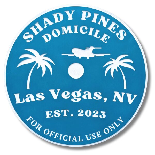 This blue Personalized Custom Round Beach House Sign features white text and graphics, including Shady Pines Domicile, Las Vegas, NV, EST. 2023, For Official Use Only, an airplane silhouette, and two palm trees, capturing a classic coastal vibe.