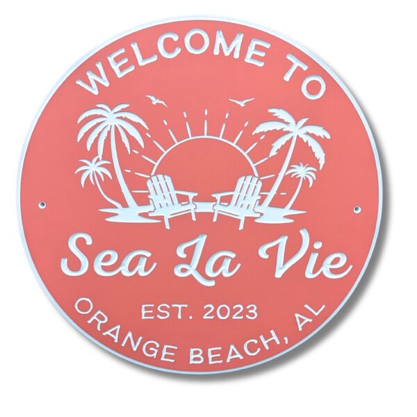 The Personalized Custom Beach House Sign features a coral color with white text: Welcome to Sea La Vie, Est. 2023, Orange Beach, AL, accompanied by palm trees, birds, and two beach chairs against a sunlit backdrop.