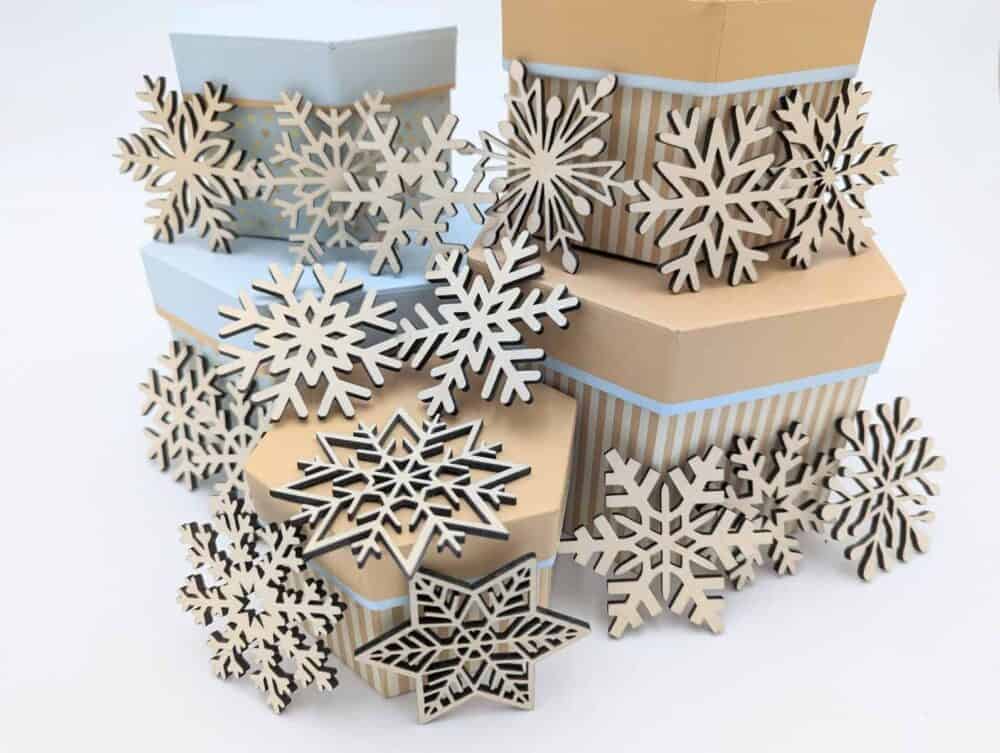 A pile of wooden snowflakes sitting on top of boxes.