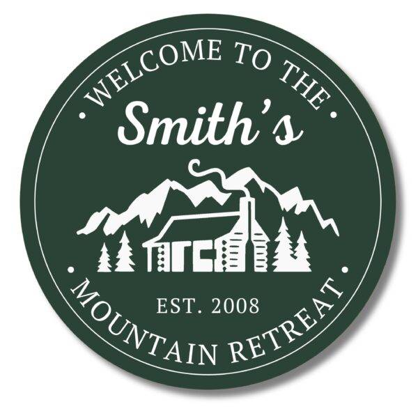 The Custom Carved Round PVC Cabin Sign welcomes guests with Welcome to the Smiths Mountain Retreat and Est. 2008, featuring a white illustration of a cabin, trees, and mountains, capturing the serene essence of this retreat beautifully.