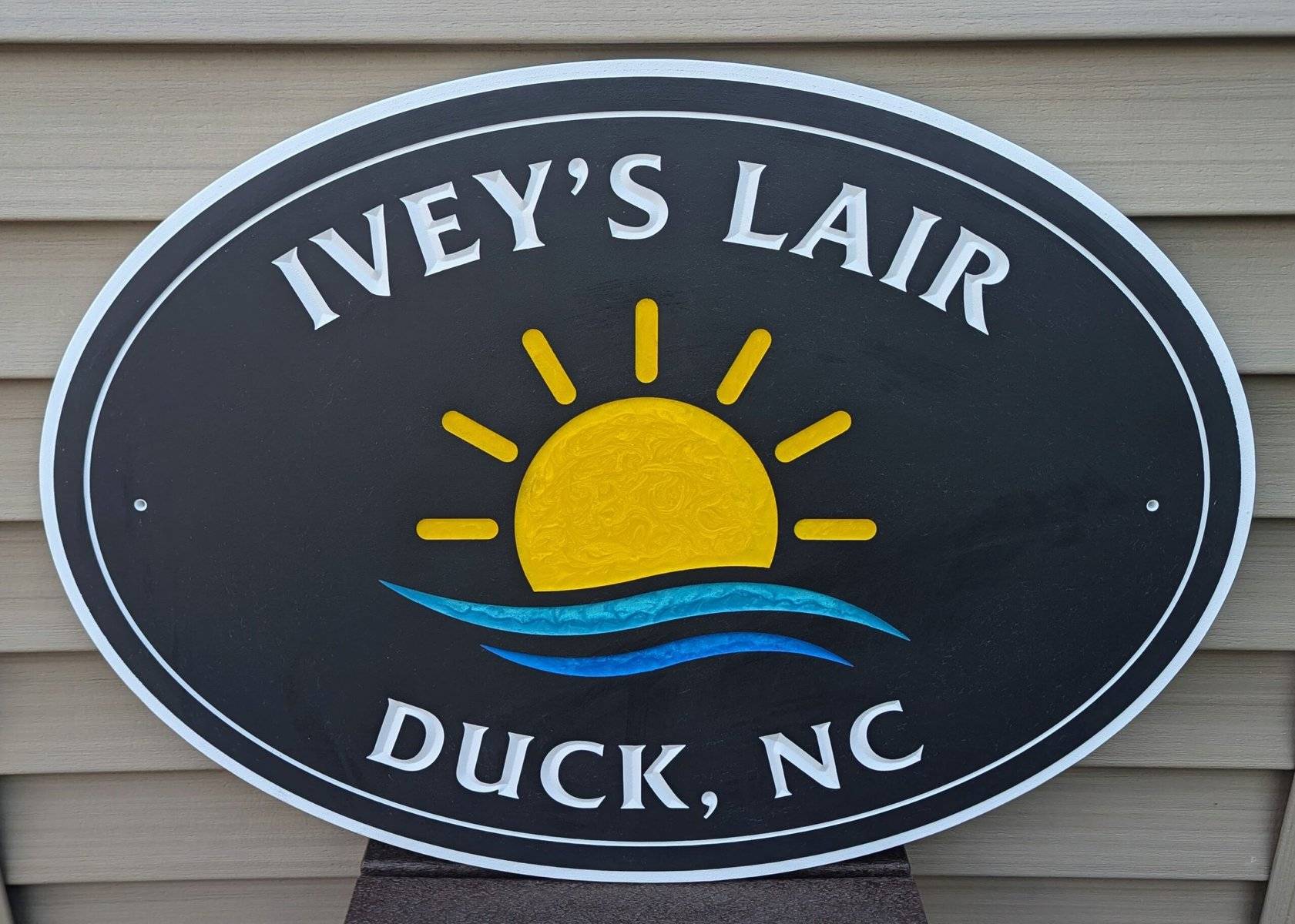 black pvc sign with sun and water epoxy inlay