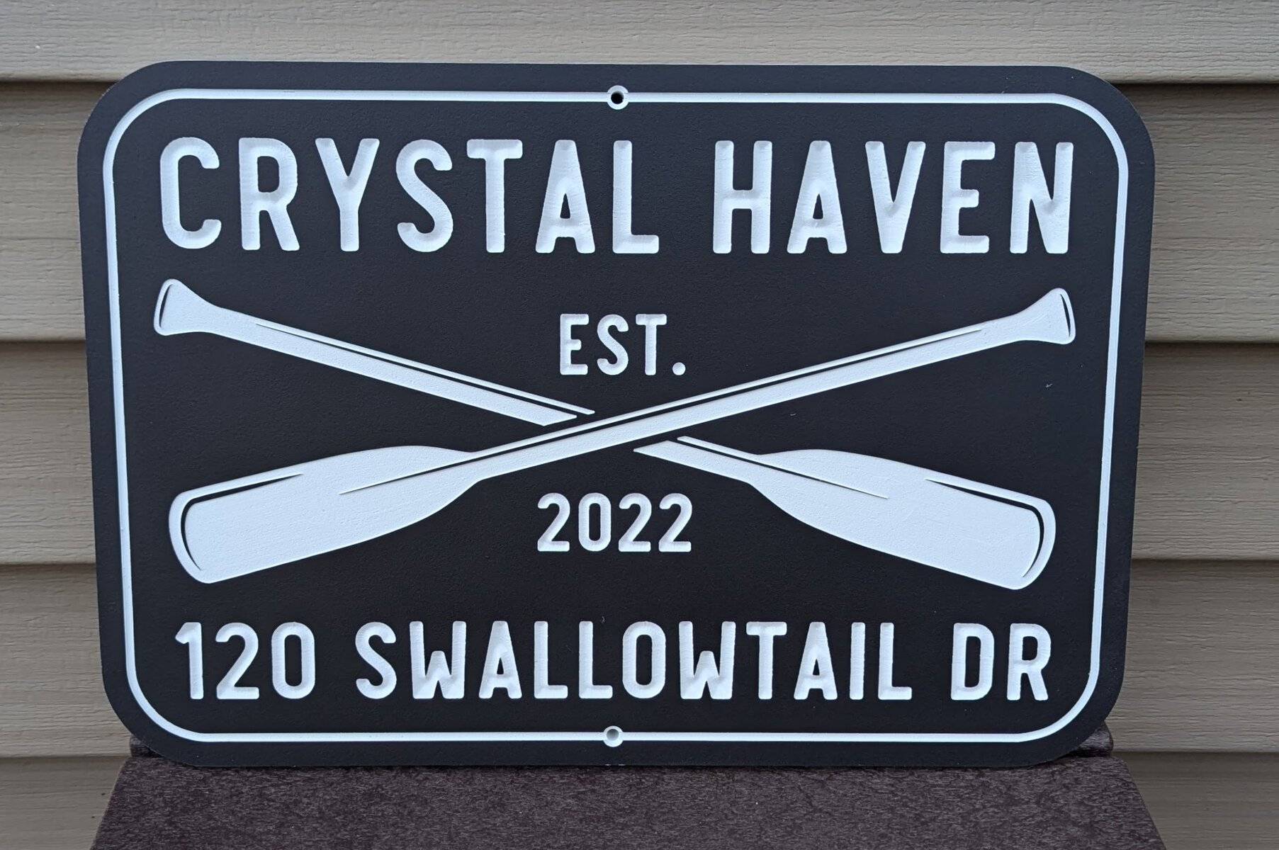 custom carved address sign with oars